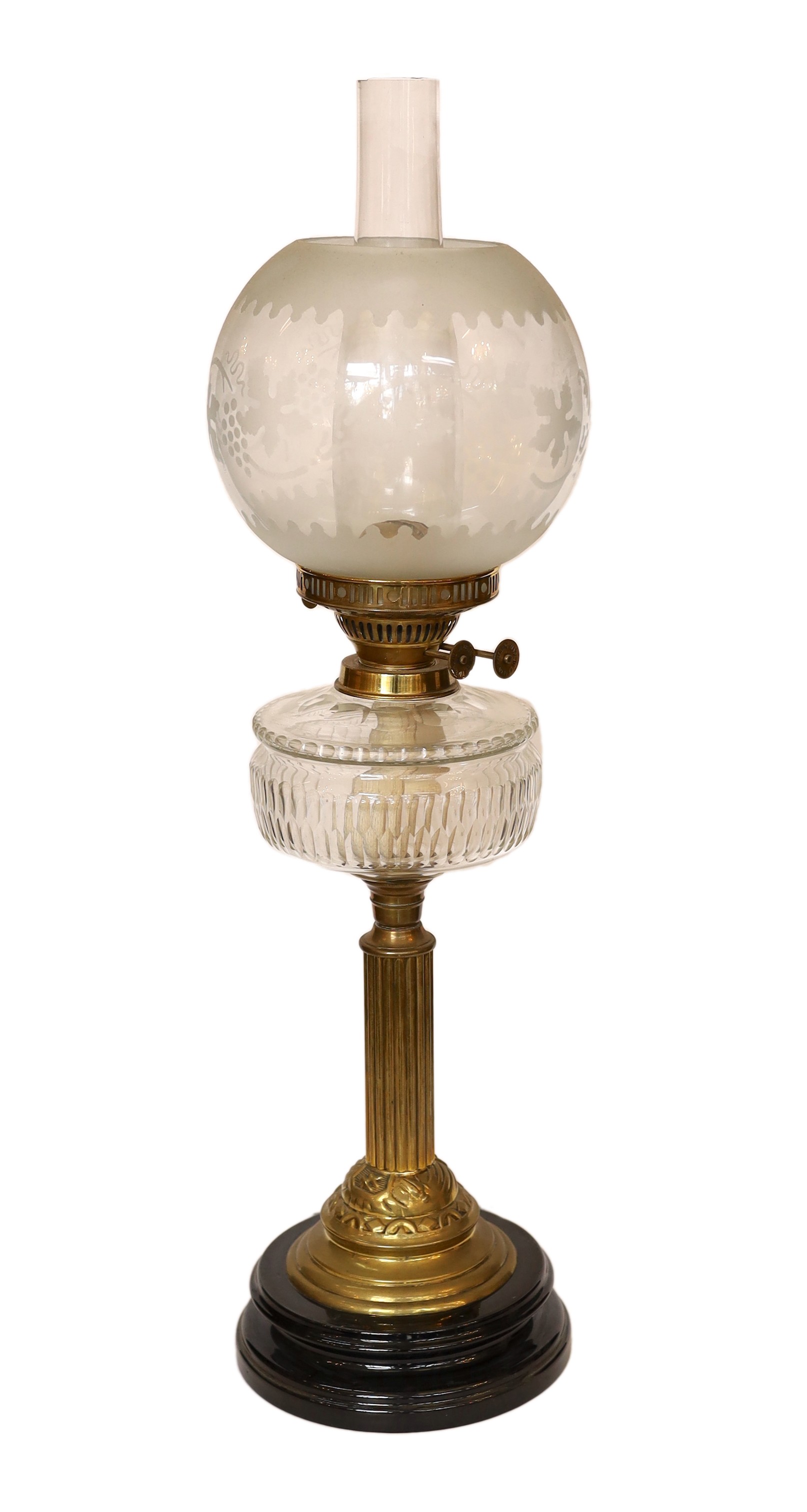 A late Victorian brass oil lamp with cut glass reservoir, duplex mechanism, etched glass globe and flue, height overall 68cm